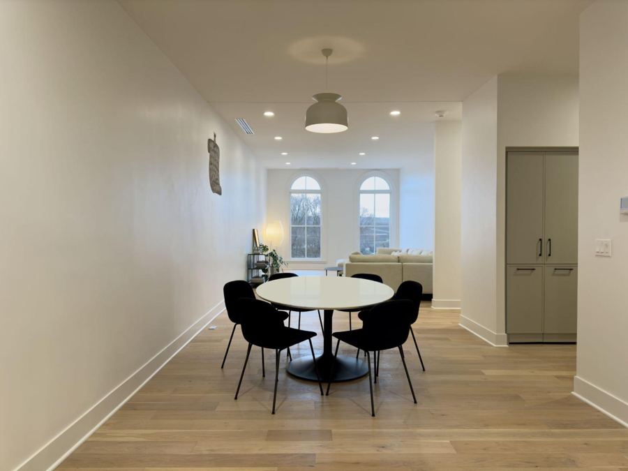 Finished suite with dining table and arched windows