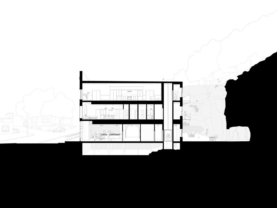 Architectural section drawing of the building against the limestone bluff